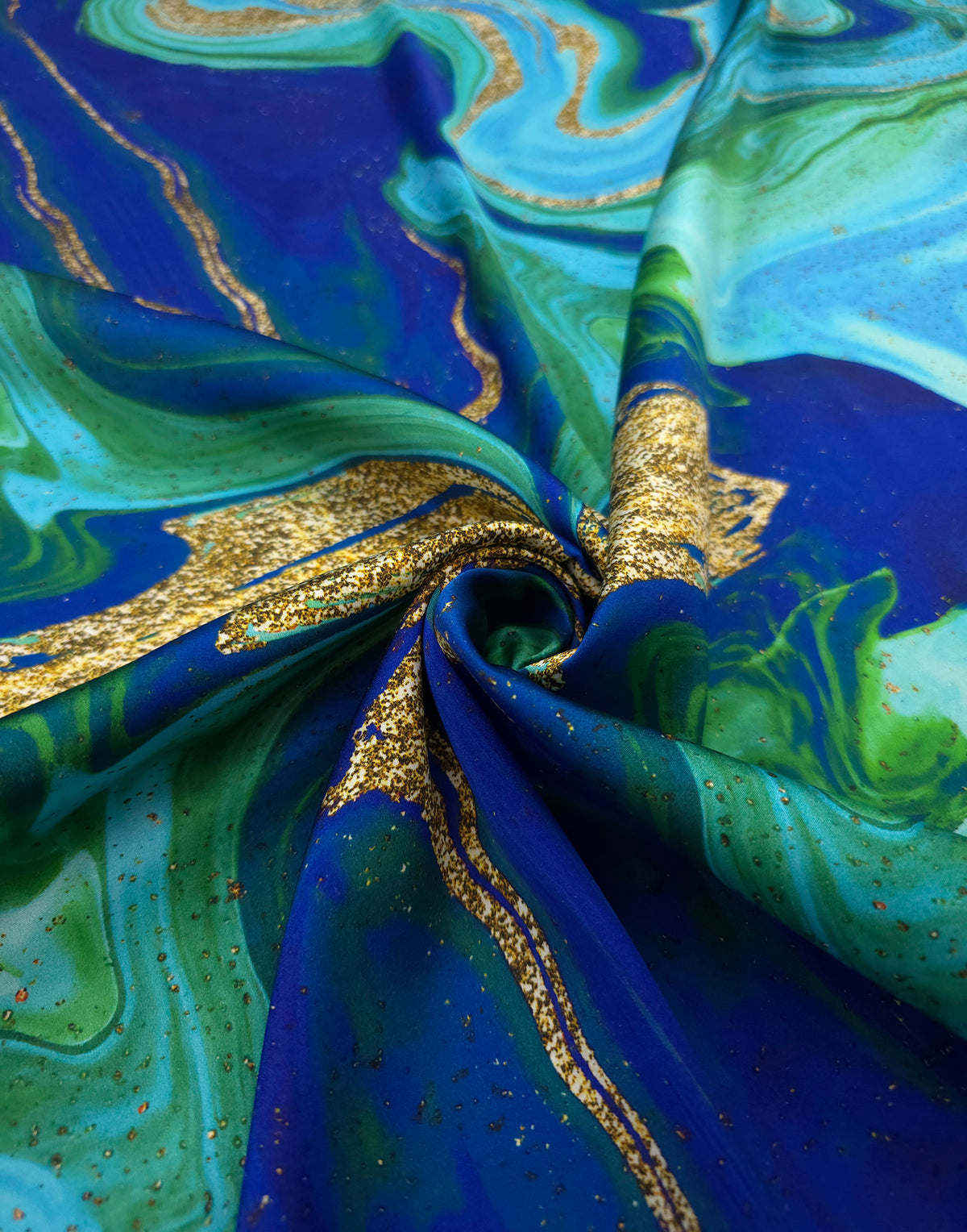Draped Italian Mulberry silk satin with an abstract print in electric blue, turquoise, green and gold tones