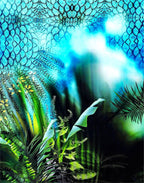 Section of Italian printed silk satin showing tropical green foliage beneath an intricate blue and black pattern.