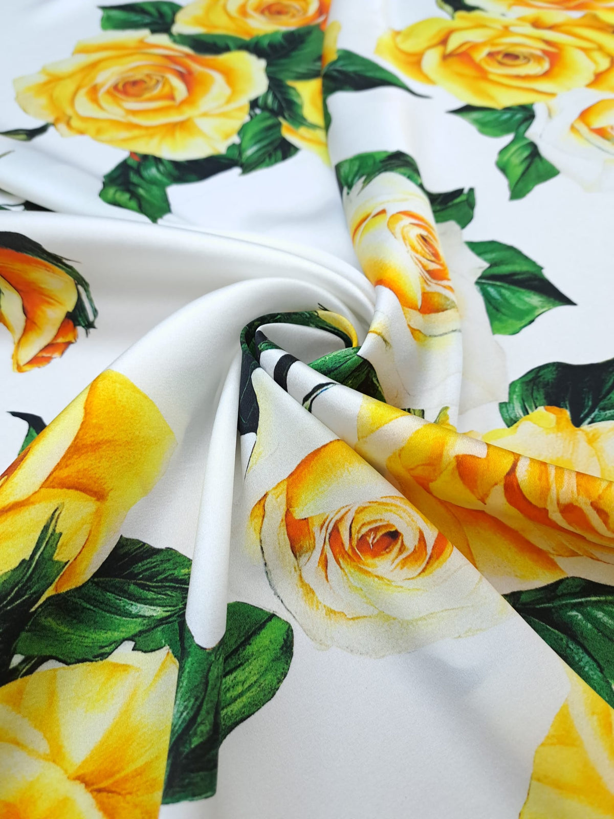 Yellow and cream rose bouquets with dark green leaves printed on white Italian silk satin.