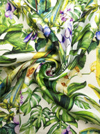 Mulberry silk satin print featuring large monstera leaves, fan-shaped foliage, purple flowers and pale orchids.