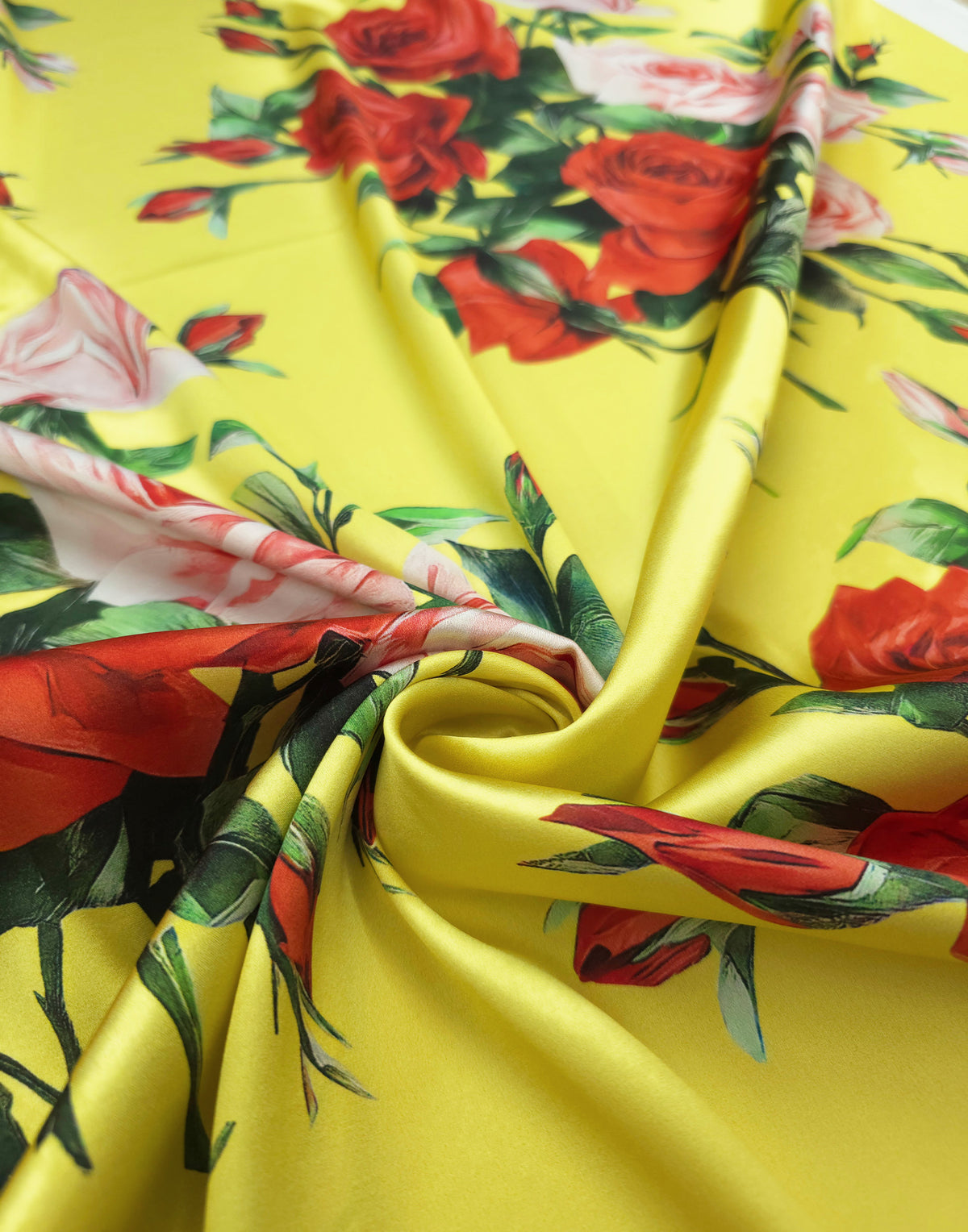 Close-up of red and pink roses printed on sunny yellow Mulberry silk satin