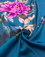 Italian Mulberry silk satin showing the pink peony, butterflies and turquoise-blue background across the fabric.