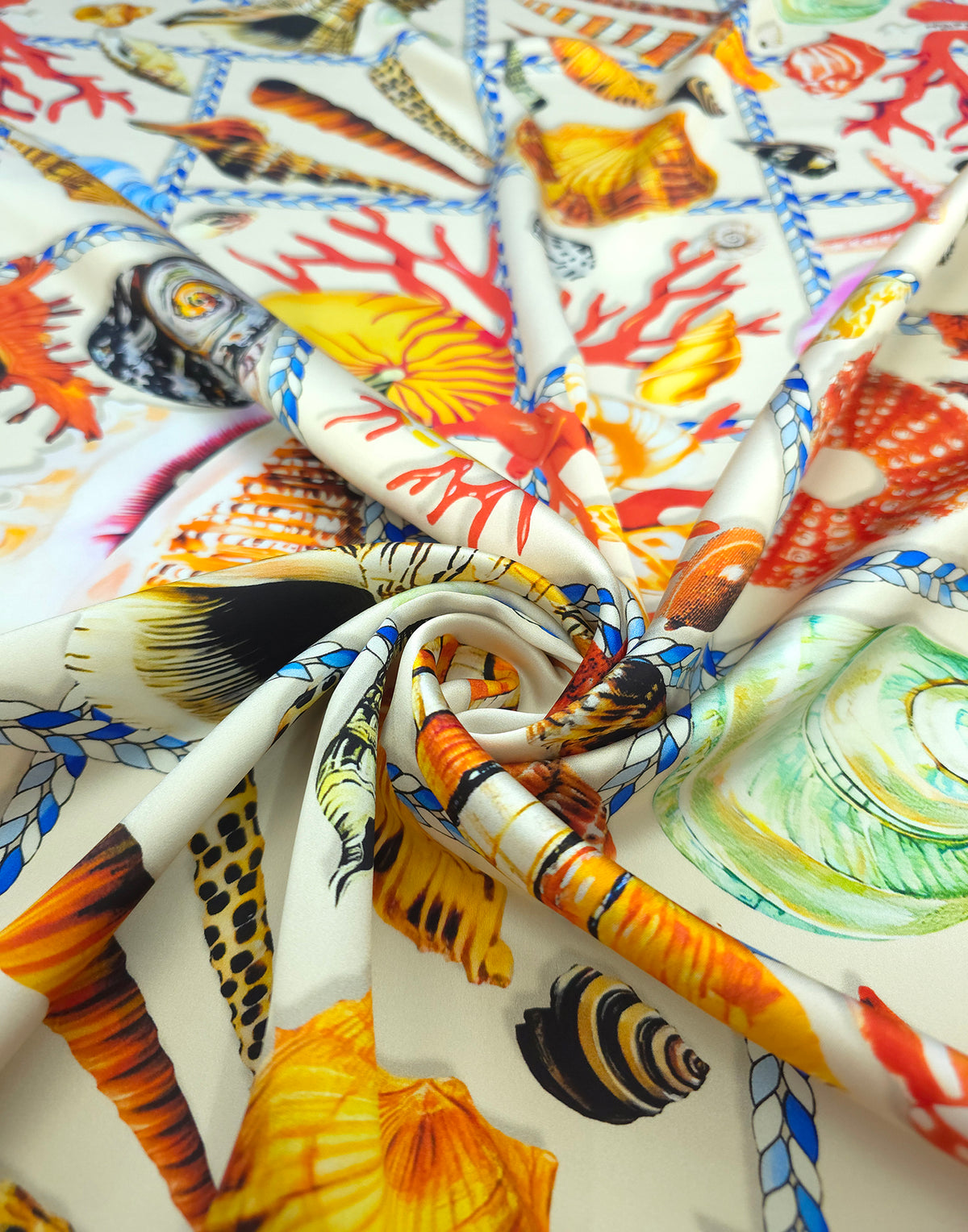 Italian printed silk satin featuring colourful seashells, starfish and vivid red coral within nautical rope frames.